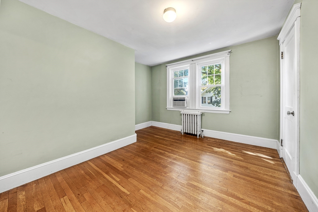 22 Linscott Road Hingham, MA 02043 - Photo 11 of 14 an empty room with wooden floor and windows