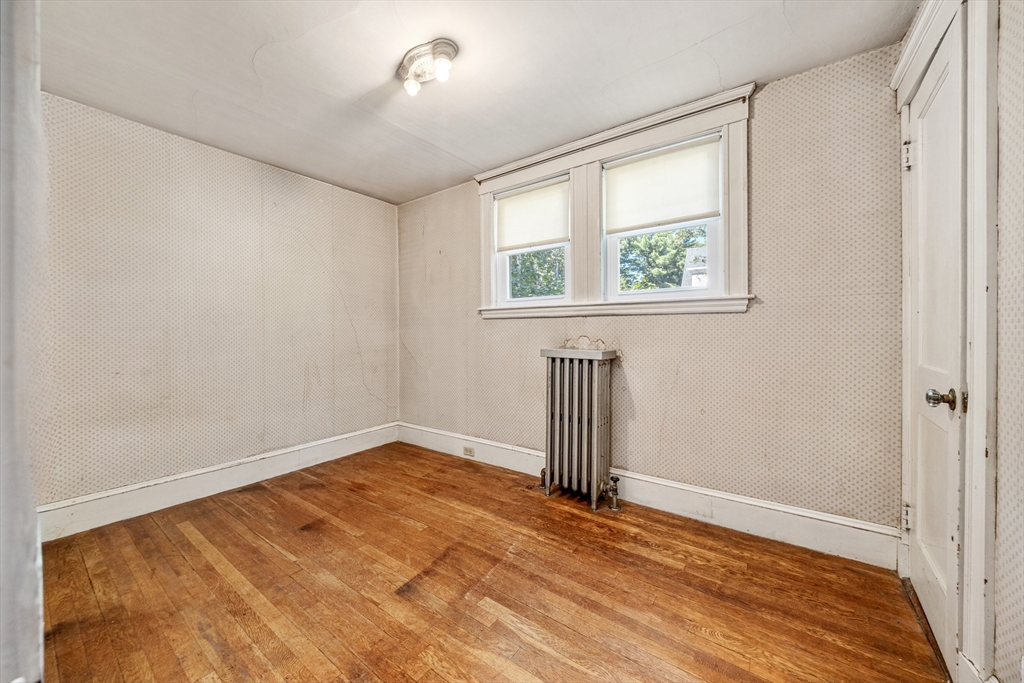 22 Linscott Road Hingham, MA 02043 - Photo 12 of 14 an empty room with wooden floor and windows