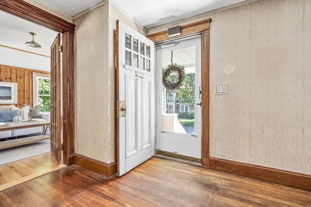22 Linscott Road Hingham, MA 02043 - Photo 8 of 14 a view of a hallway with wooden floor and a livingroom view