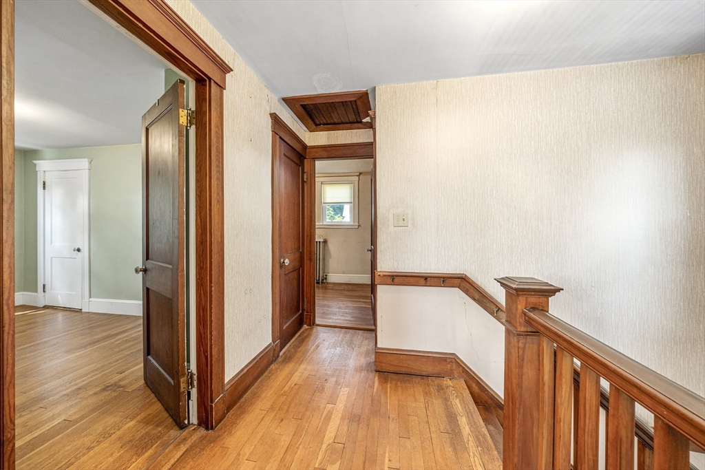 22 Linscott Road Hingham, MA 02043 - Photo 10 of 14 a view of a hallway with wooden floor and staircase