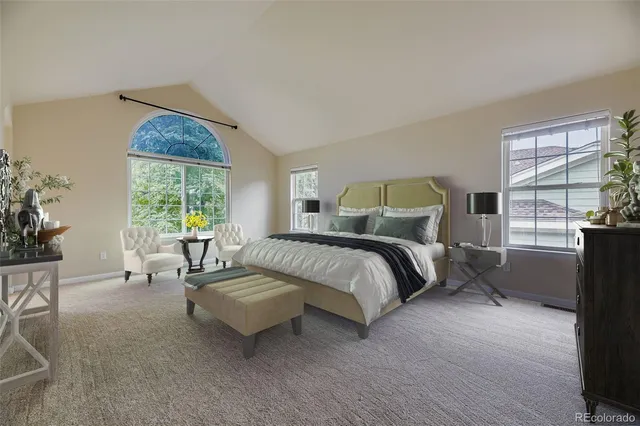 a spacious bedroom with a bed and glass window