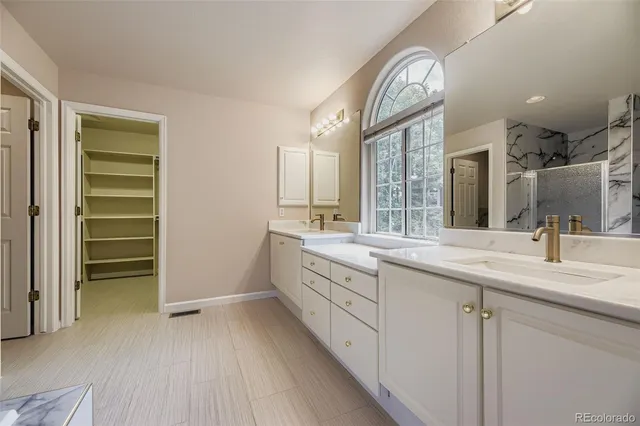 a bathroom with a double vanity sink and a mirror