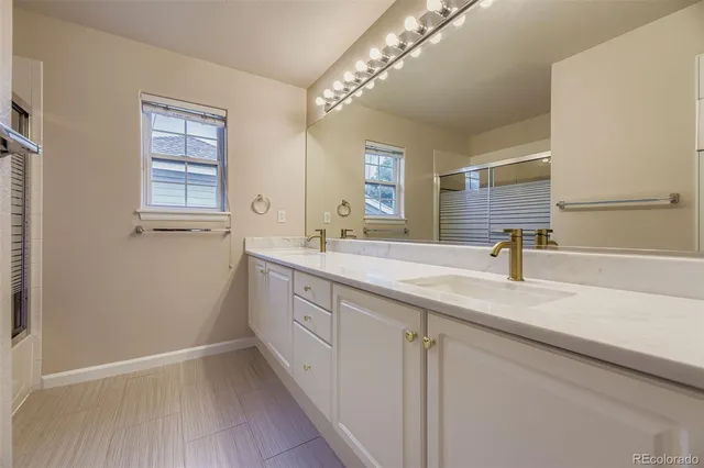 a bathroom with a double vanity sink and a mirror
