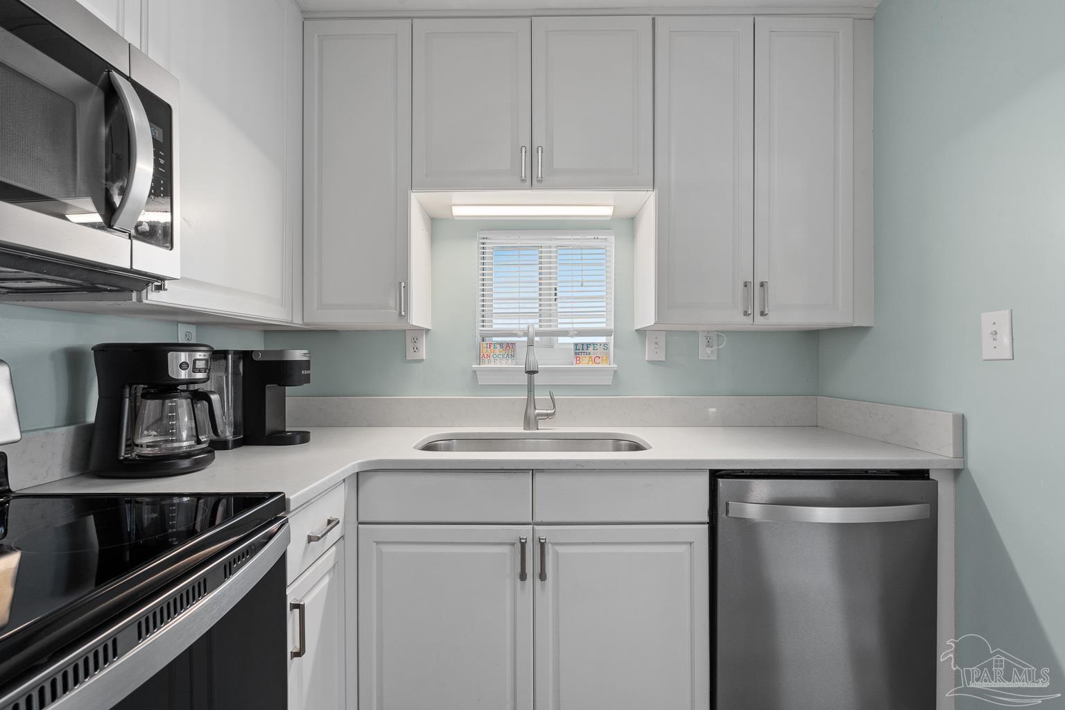 16470 Perdido Key Drive, Unit A 24 Perdido Key, FL 32507 - Photo 14 of 60 a kitchen with a sink and cabinets