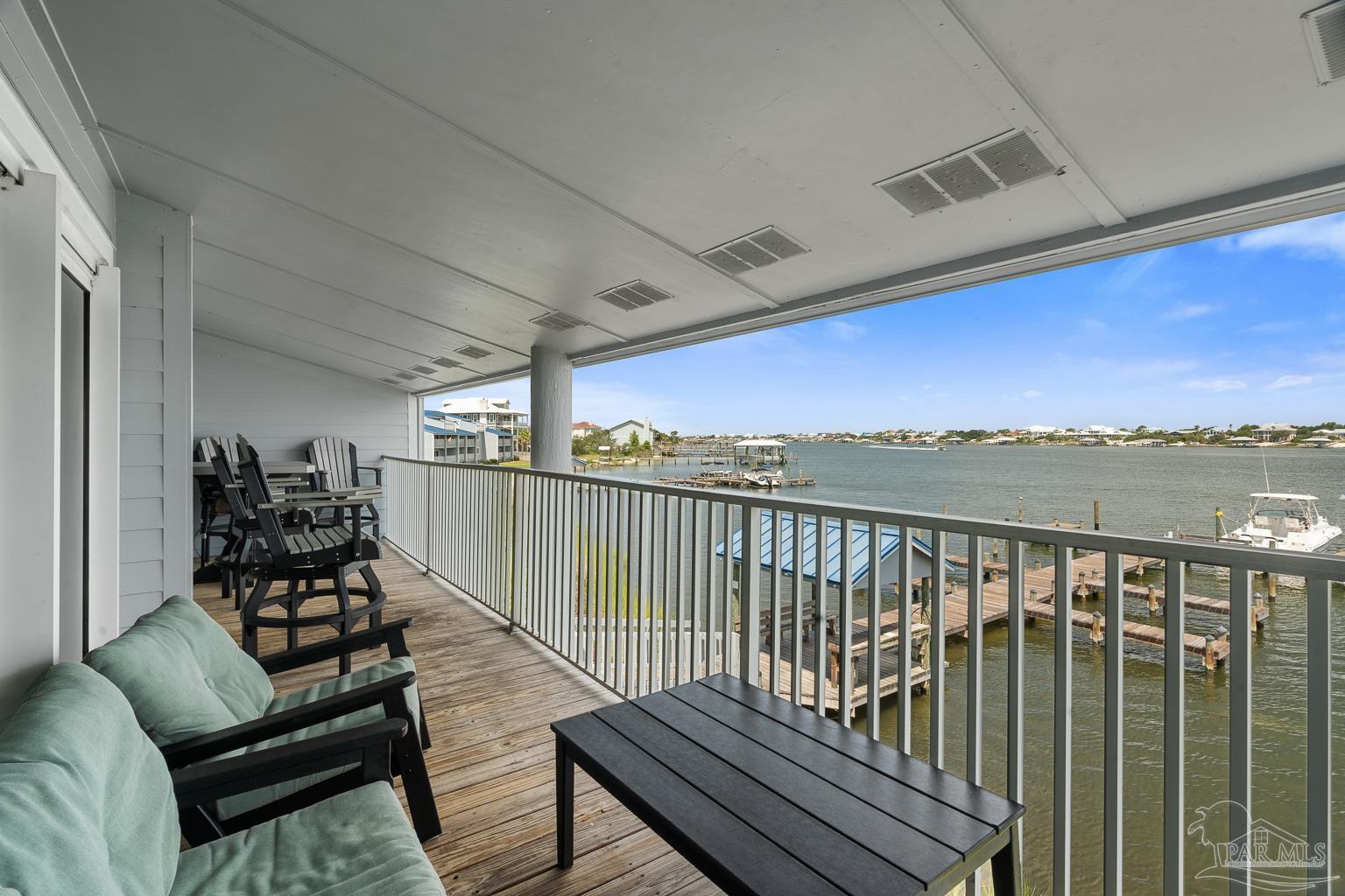 16470 Perdido Key Drive, Unit A 24 Perdido Key, FL 32507 - Photo 18 of 60 a balcony with wooden floor outdoor seating and city view
