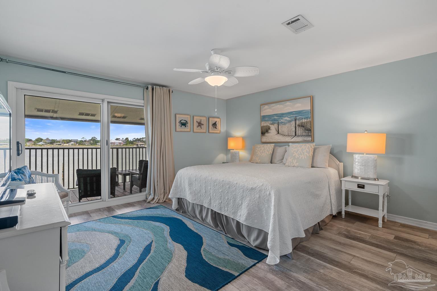 16470 Perdido Key Drive, Unit A 24 Perdido Key, FL 32507 - Photo 22 of 60 a spacious bedroom with a bed and wooden floor