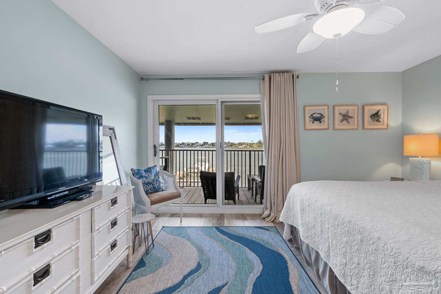 16470 Perdido Key Drive, Unit A 24 Perdido Key, FL 32507 - Photo 23 of 60 a bedroom with a bed and a flat screen tv