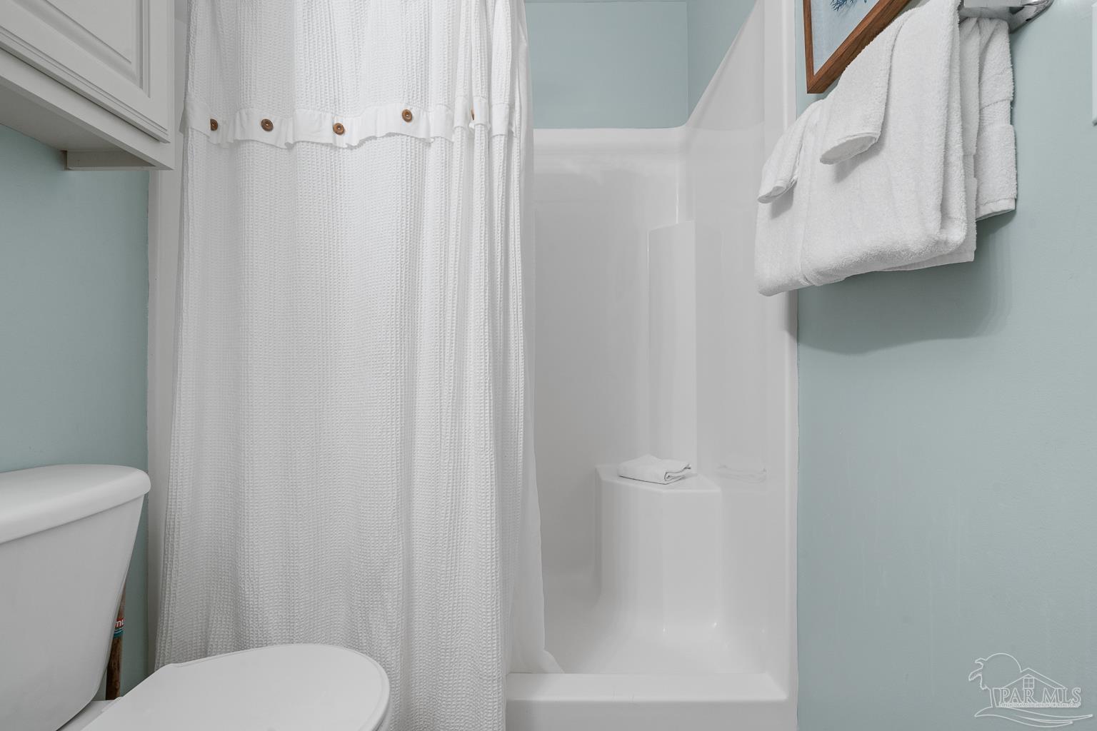 16470 Perdido Key Drive, Unit A 24 Perdido Key, FL 32507 - Photo 27 of 60 a white toilet sitting next to a shower curtain