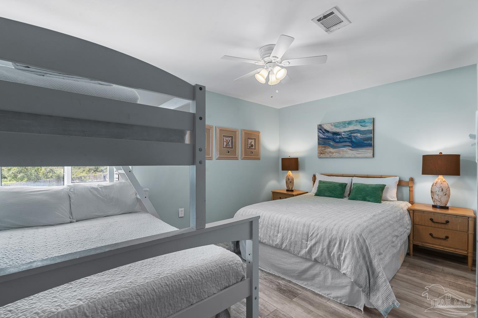 16470 Perdido Key Drive, Unit A 24 Perdido Key, FL 32507 - Photo 28 of 60 a bedroom with a bed and a chandelier