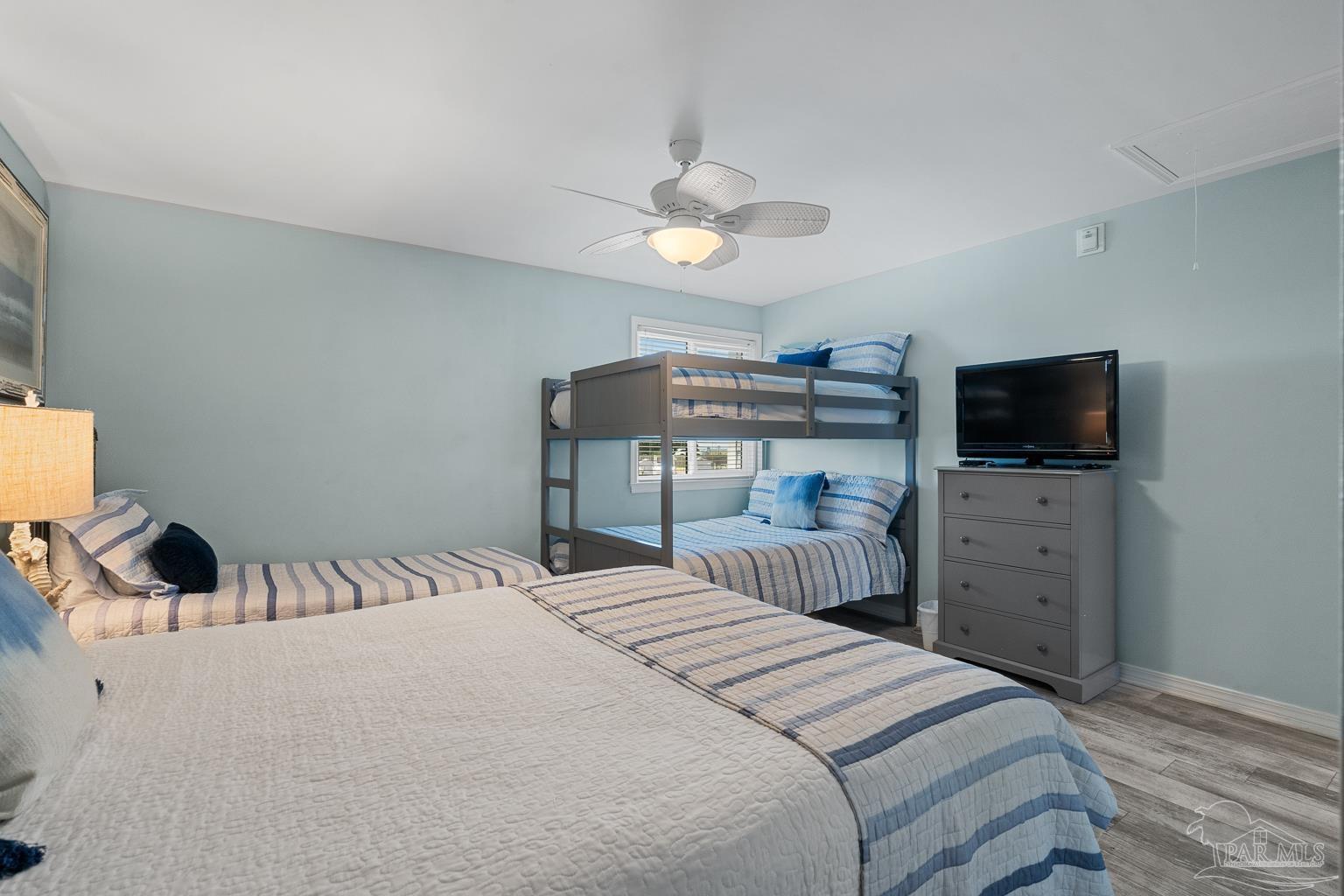 16470 Perdido Key Drive, Unit A 24 Perdido Key, FL 32507 - Photo 31 of 60 a bedroom with a bed and a flat screen tv