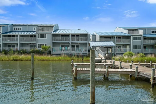 a view of swimming pool with outdoor seating and lake view