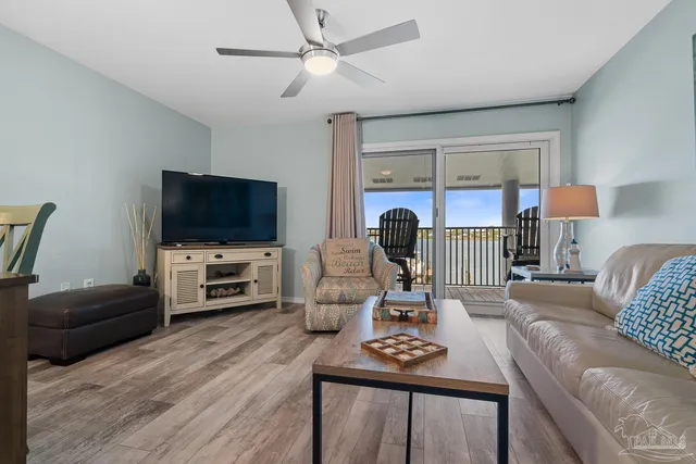 a living room with furniture a flat screen tv and a window