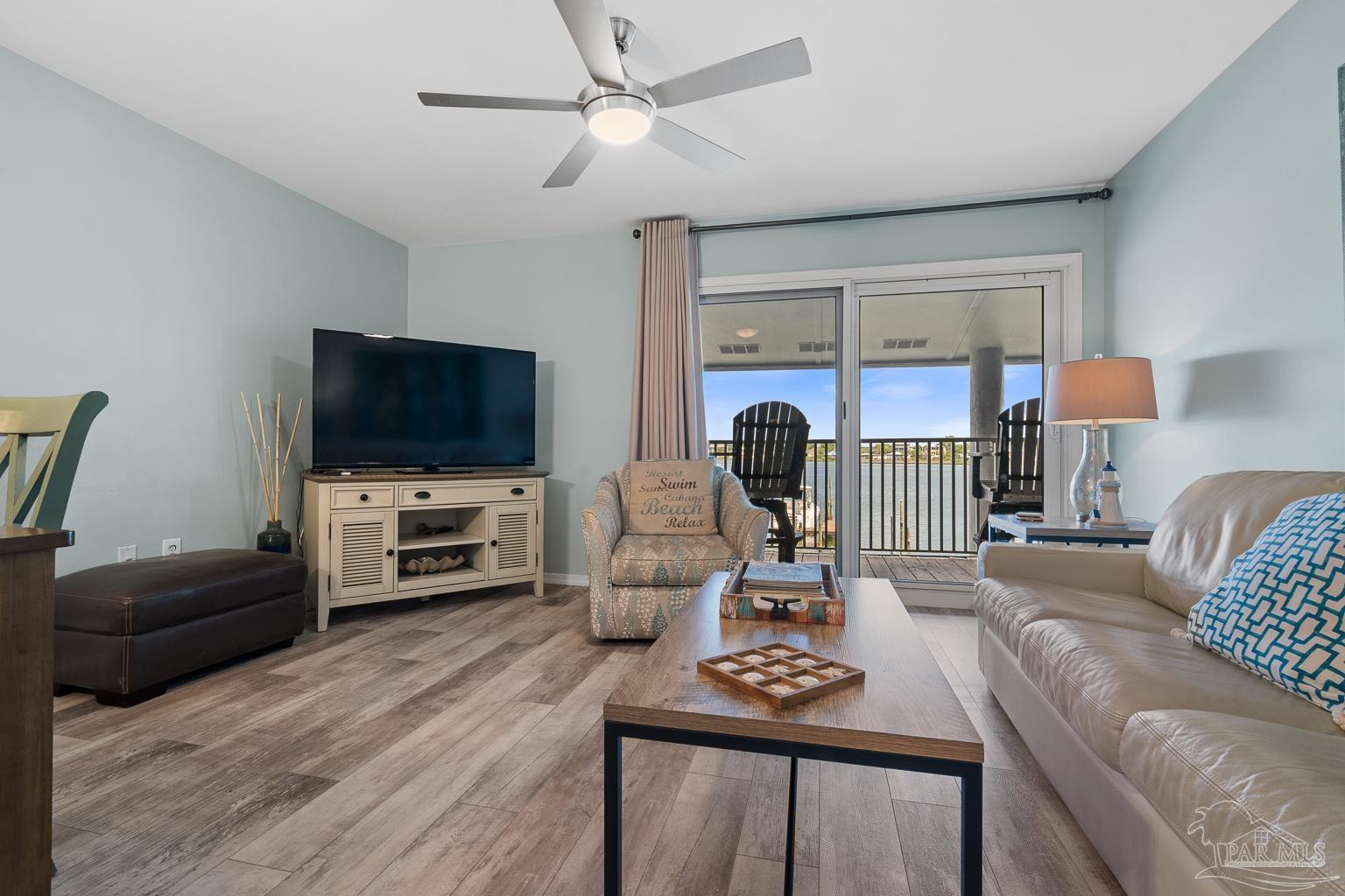 16470 Perdido Key Drive, Unit A 24 Perdido Key, FL 32507 - Photo 5 of 60 a living room with furniture a flat screen tv and a window