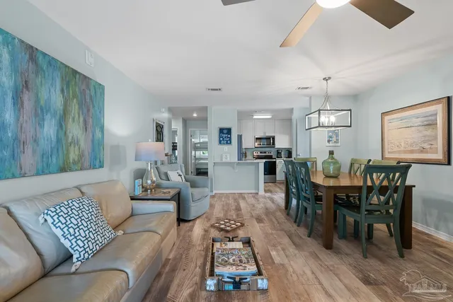 a living room with furniture dining table a window and appliances