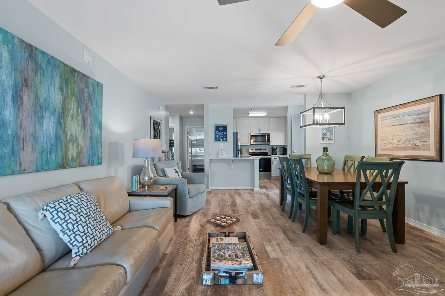 16470 Perdido Key Drive, Unit A 24 Perdido Key, FL 32507 - Photo 8 of 60 a living room with furniture dining table a window and appliances