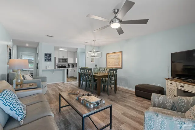 a living room with furniture a rug and a flat screen tv