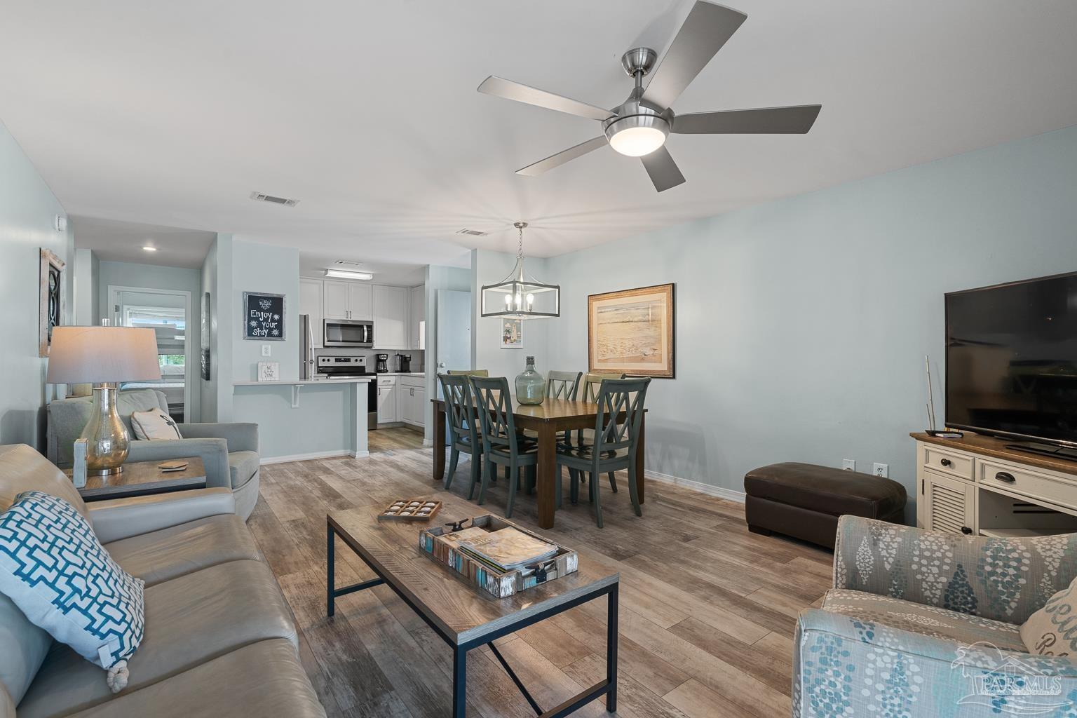 16470 Perdido Key Drive, Unit A 24 Perdido Key, FL 32507 - Photo 9 of 60 a living room with furniture a rug and a flat screen tv