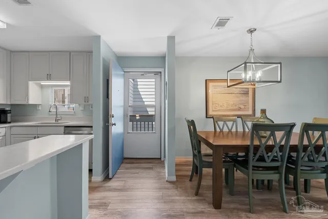 a kitchen with cabinets and wooden floor