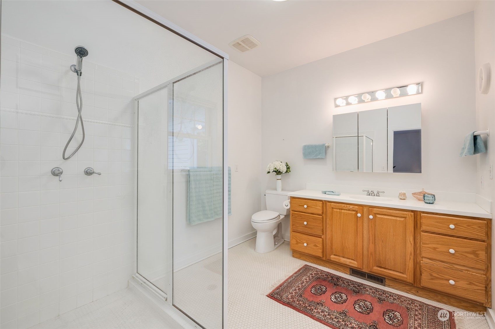23406 Landers Road Southwest Vashon, WA 98070 - Photo 15 of 39 a spacious bathroom with a double vanity sink toilet mirror and bathtub