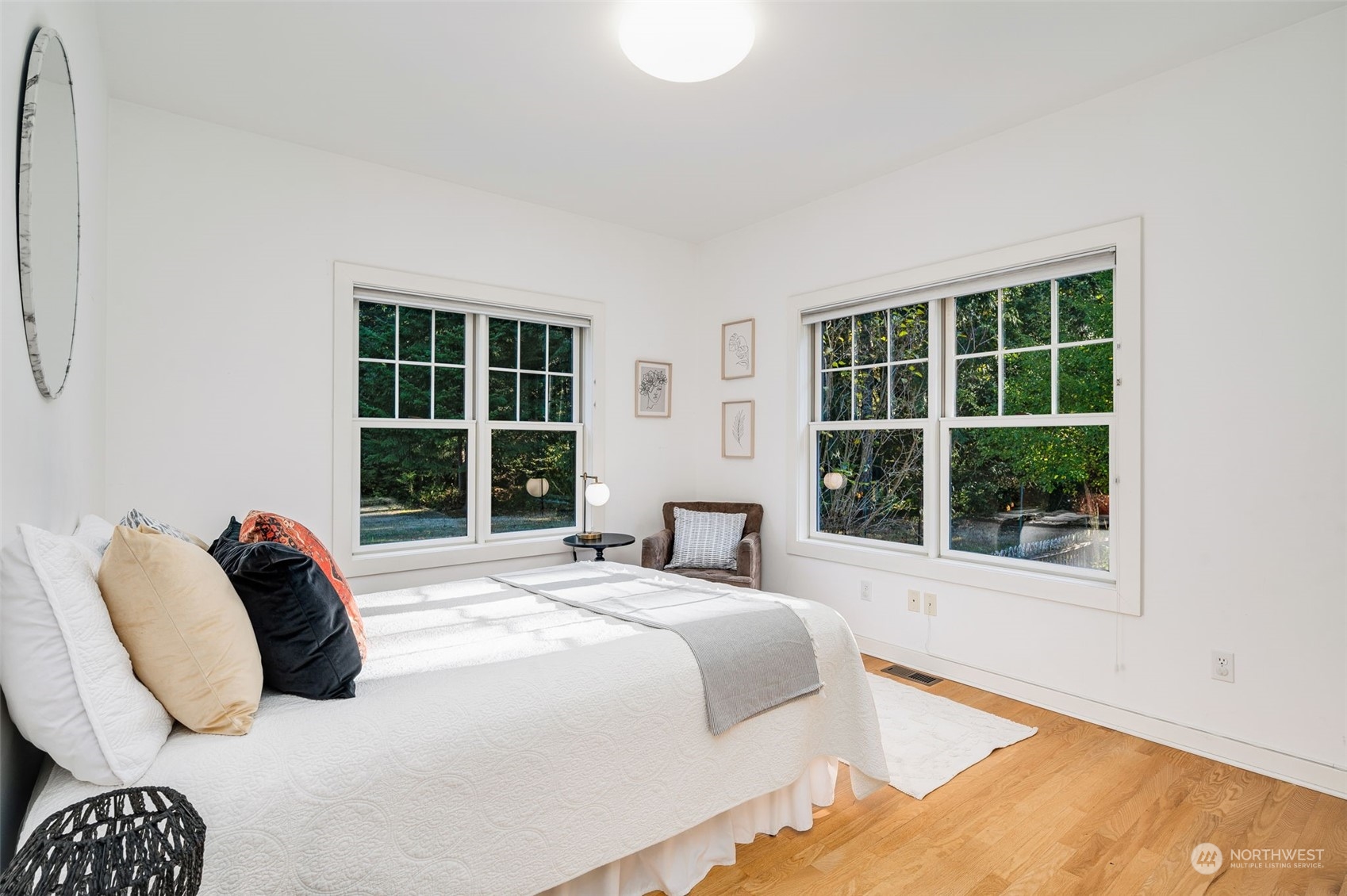 23406 Landers Road Southwest Vashon, WA 98070 - Photo 16 of 39 a bedroom with a bed and a large window