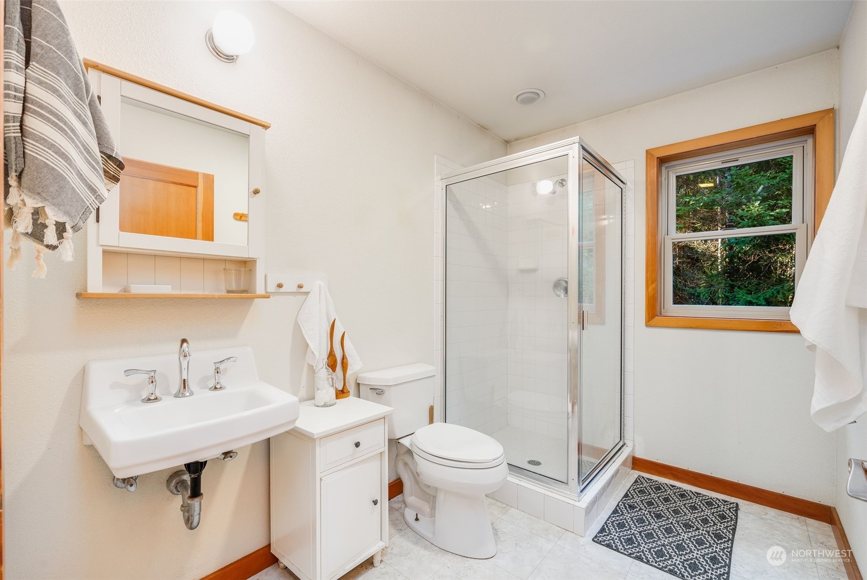 23406 Landers Road Southwest Vashon, WA 98070 - Photo 27 of 39 a bathroom with a sink a toilet and shower