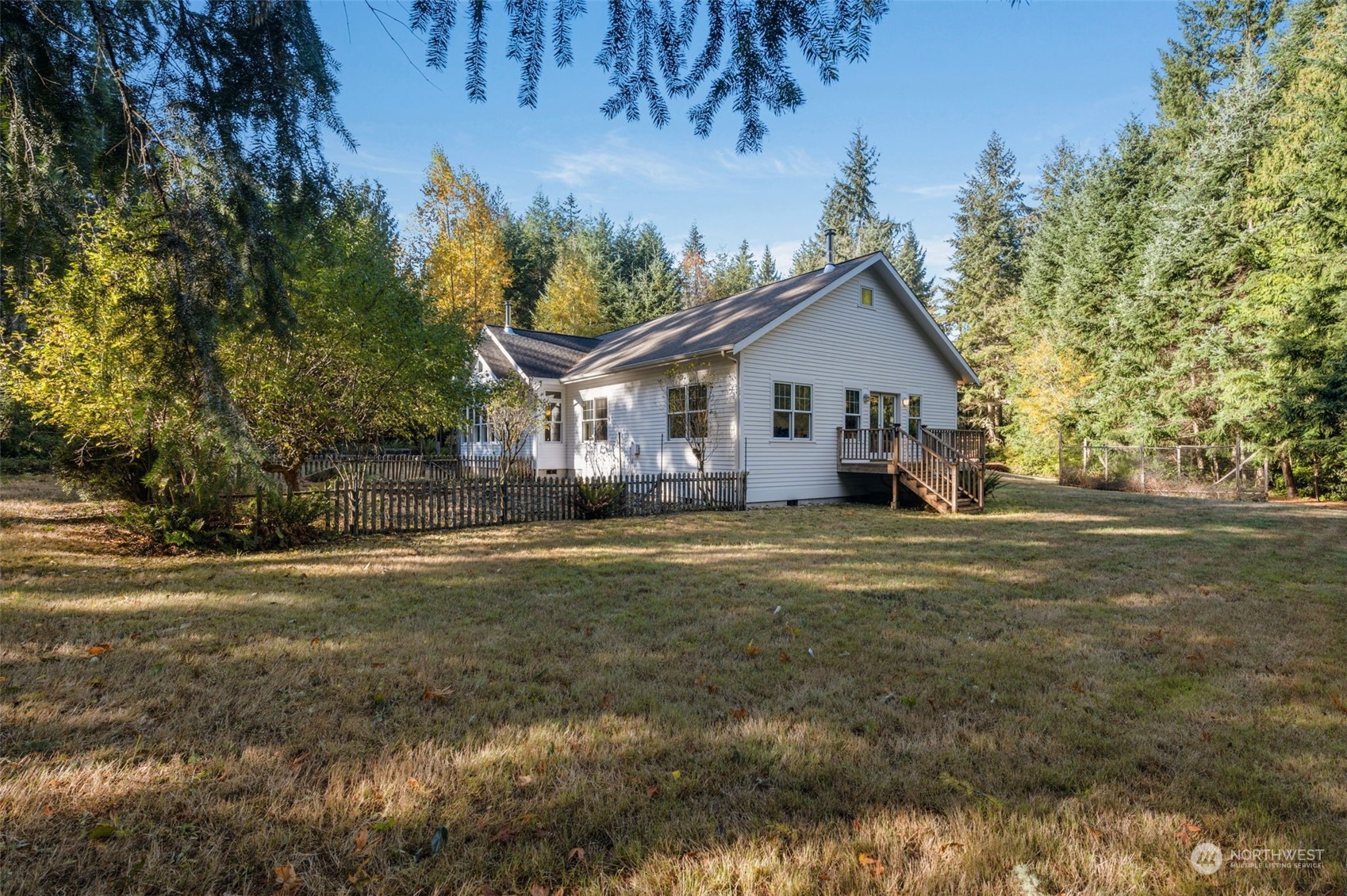 23406 Landers Road Southwest Vashon, WA 98070 - Photo 30 of 39 a front view of a house with a garden and trees