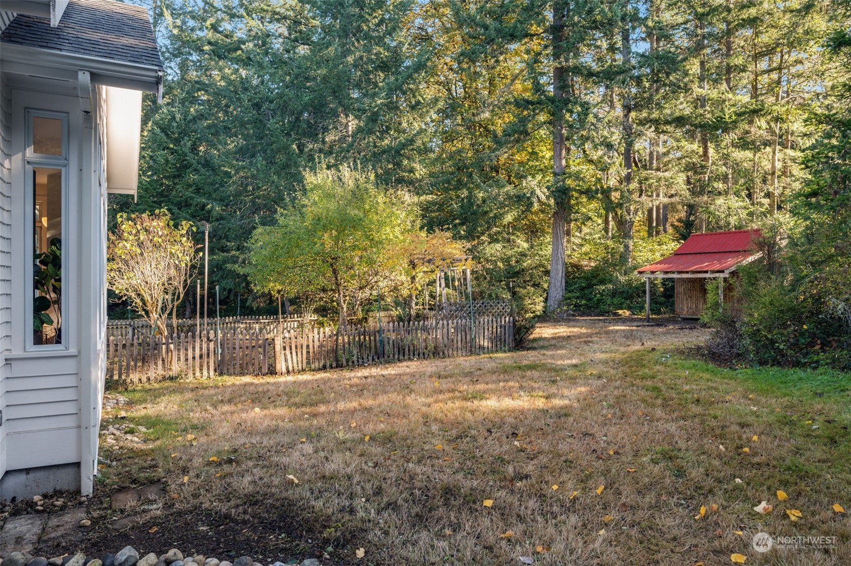 23406 Landers Road Southwest Vashon, WA 98070 - Photo 33 of 39 a backyard of a house with table and chairs