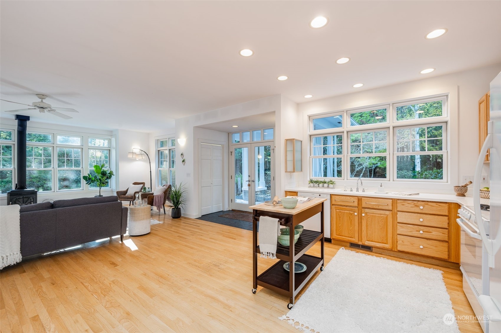 23406 Landers Road Southwest Vashon, WA 98070 - Photo 7 of 39 a view of a kitchen with kitchen island wooden floor and living room