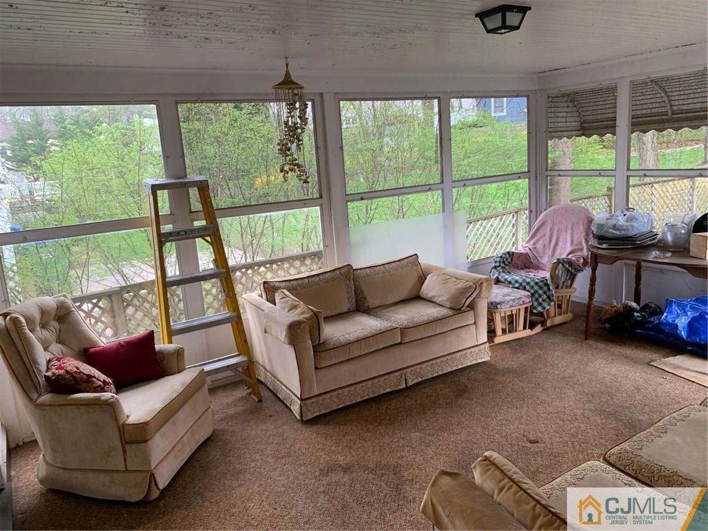 18 Hill Road Edison, NJ 08817 - Photo 6 of 13 a living room with furniture and a floor to ceiling window