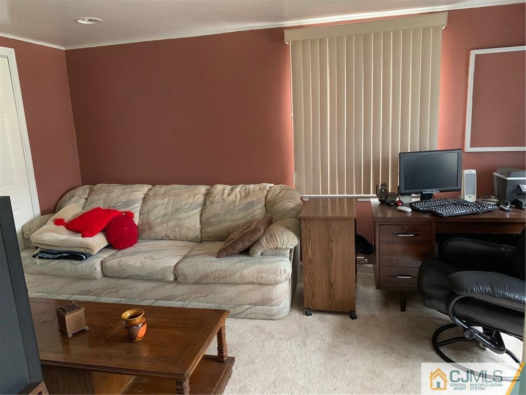 18 Hill Road Edison, NJ 08817 - Photo 9 of 13 a living room with furniture and a flat screen tv
