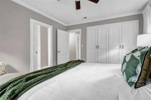 a bedroom with a bed a mirror and couch