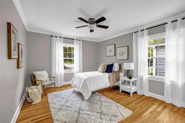 a spacious bedroom with a bed and a window