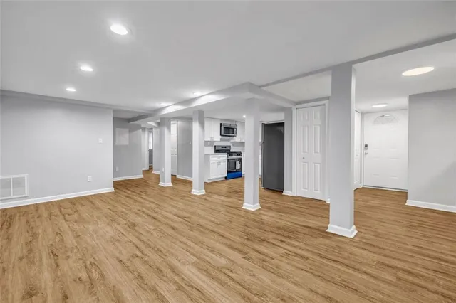 a view of empty room with wooden floor