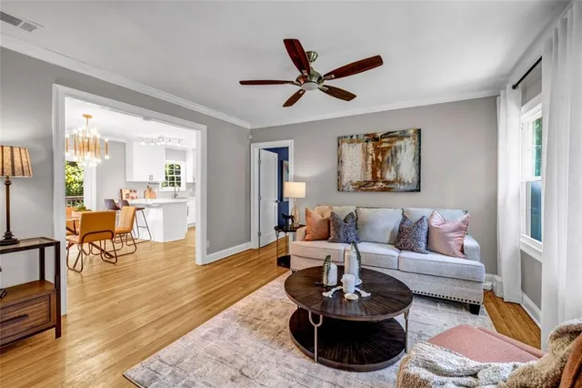 a living room with furniture and a wooden floor
