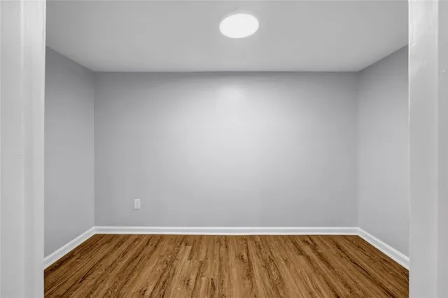 a view of room with window and wooden floor