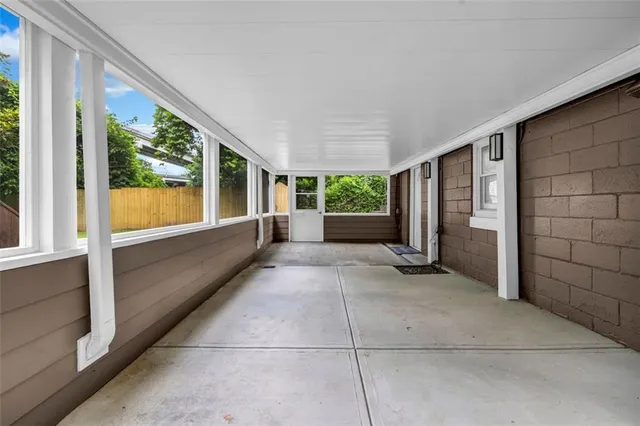 a view of outdoor space with wooden floor and windows