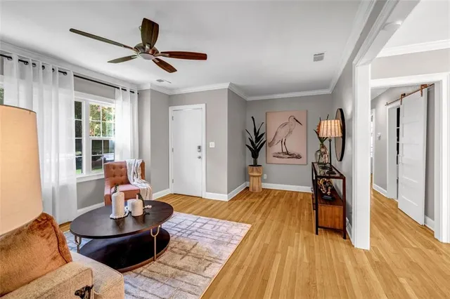 a living room with furniture and a wooden floor