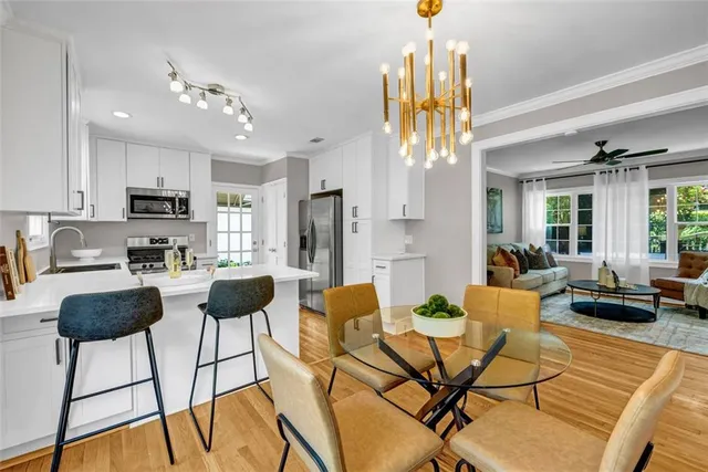 a view of a dining room with furniture and a chandelier