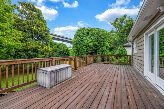a view of balcony with wooden floor and fence