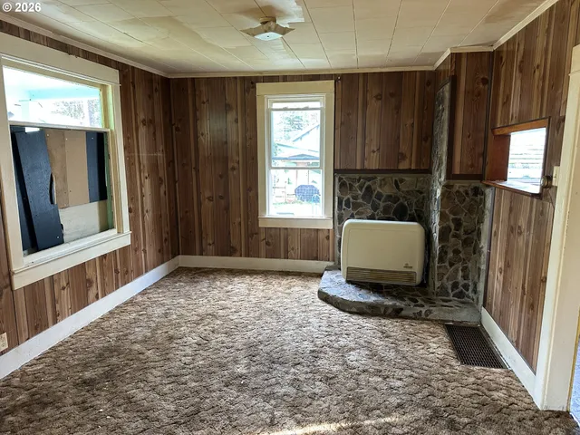 a living room with hard wood floors and a window
