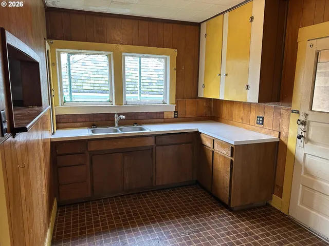 a kitchen with a sink cabinets and appliances