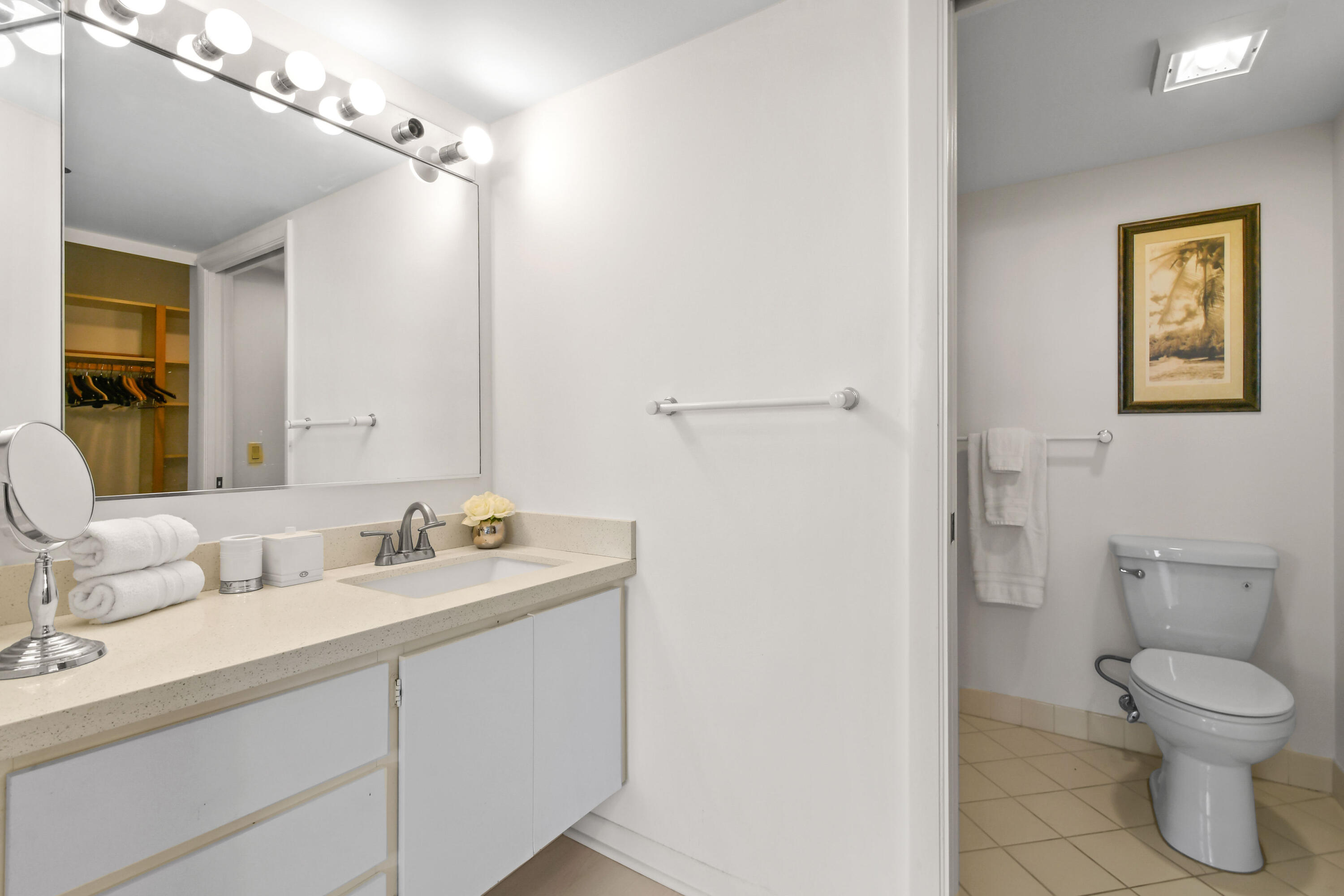 Undisclosed Address Jupiter, FL 33477 - Photo 11 of 23 a bathroom with a toilet sink and mirror