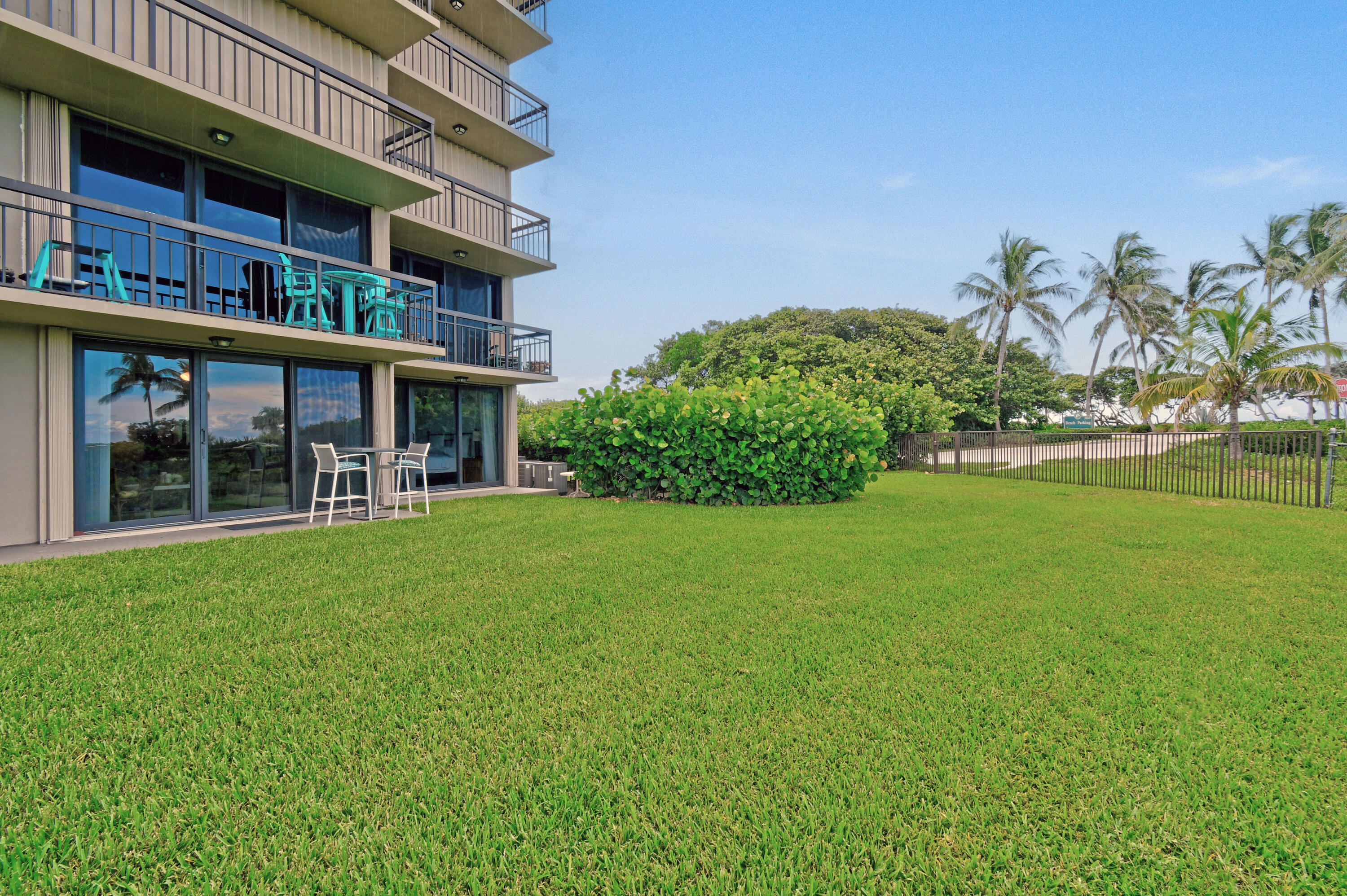 Undisclosed Address Jupiter, FL 33477 - Photo 18 of 23 a view of a house with a yard and a garden