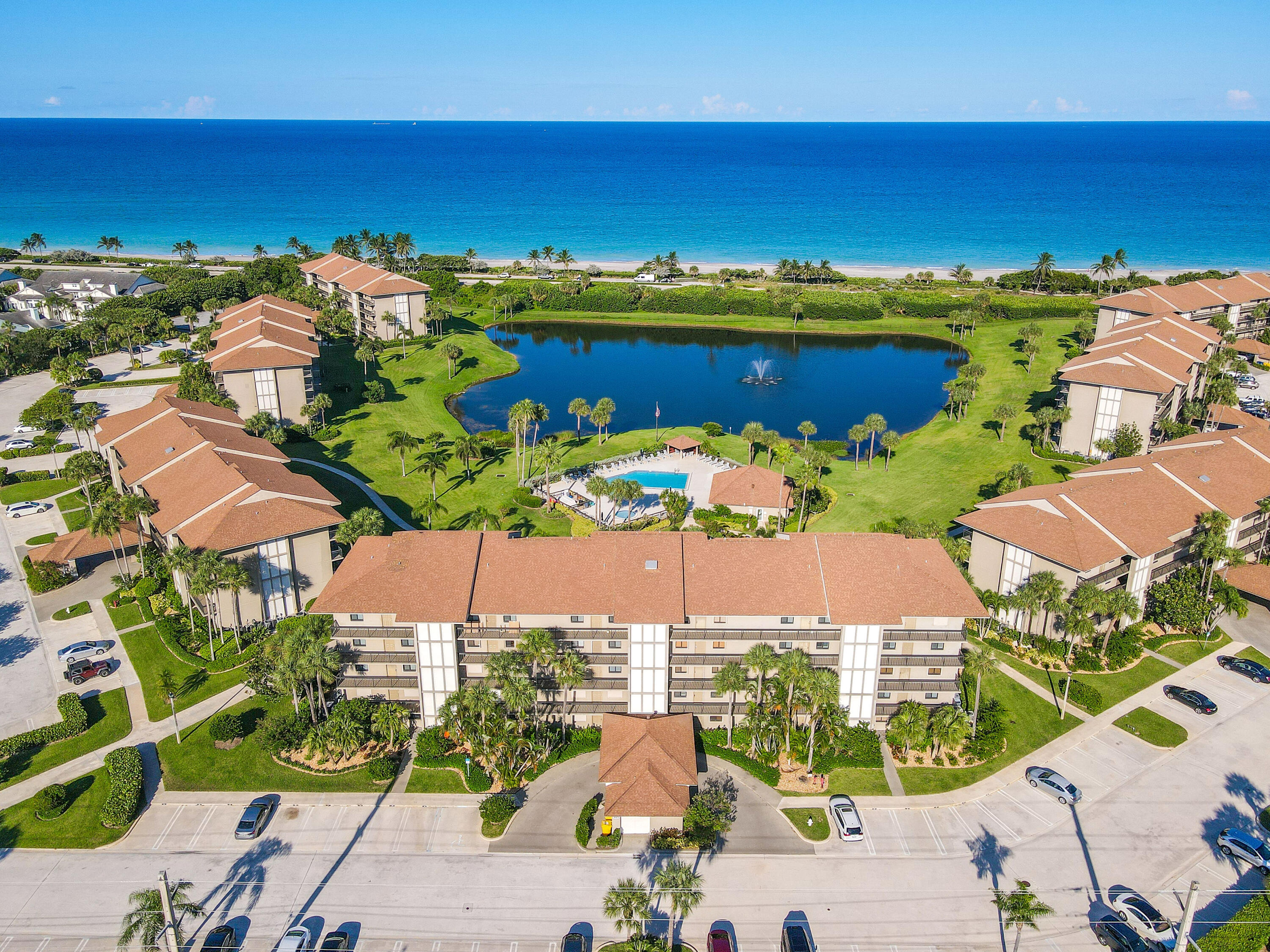 Undisclosed Address Jupiter, FL 33477 - Photo 3 of 23 an aerial view of residential houses with outdoor space and ocean view
