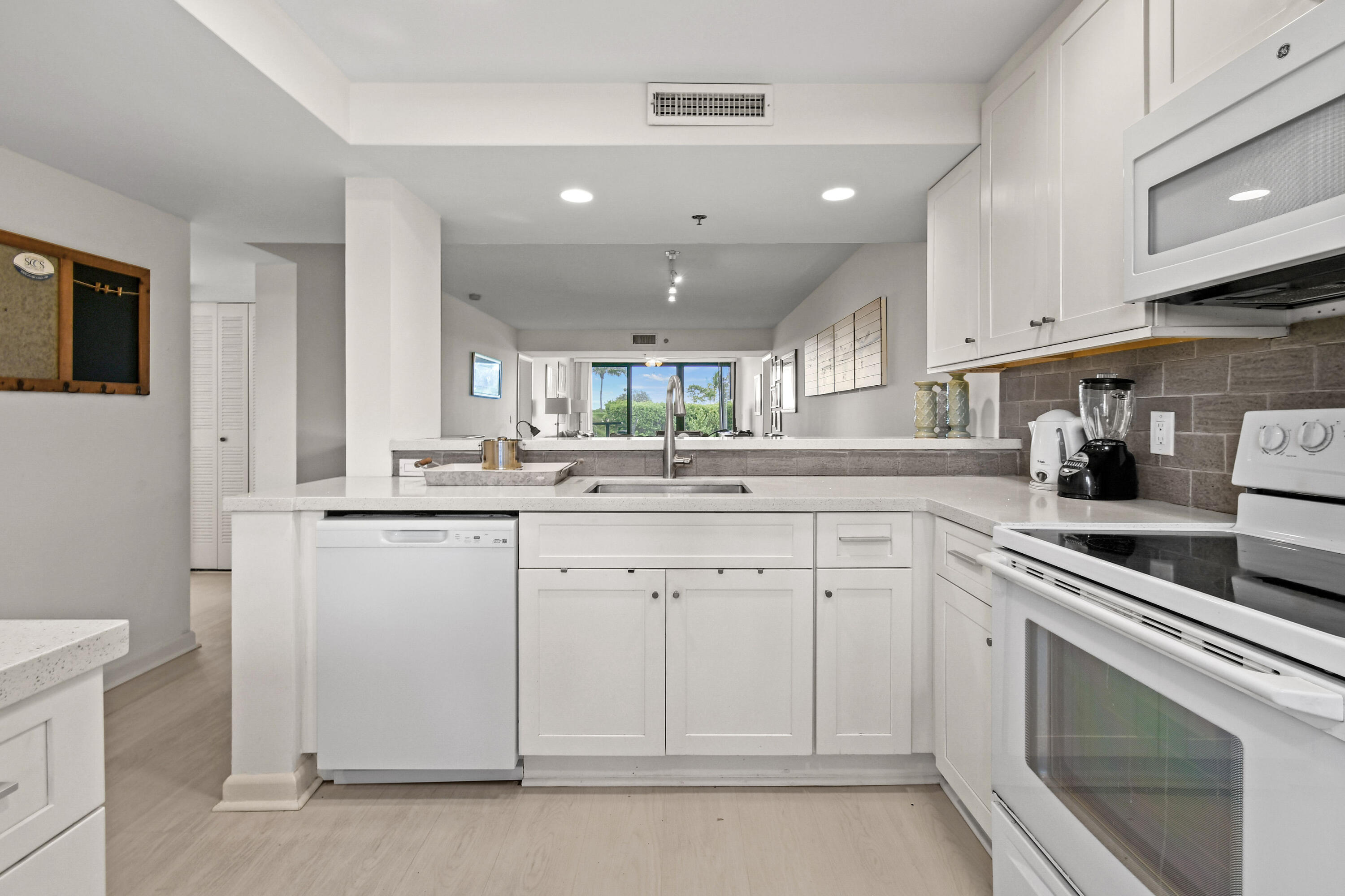 Undisclosed Address Jupiter, FL 33477 - Photo 5 of 23 a kitchen with white cabinets stainless steel appliances and sink