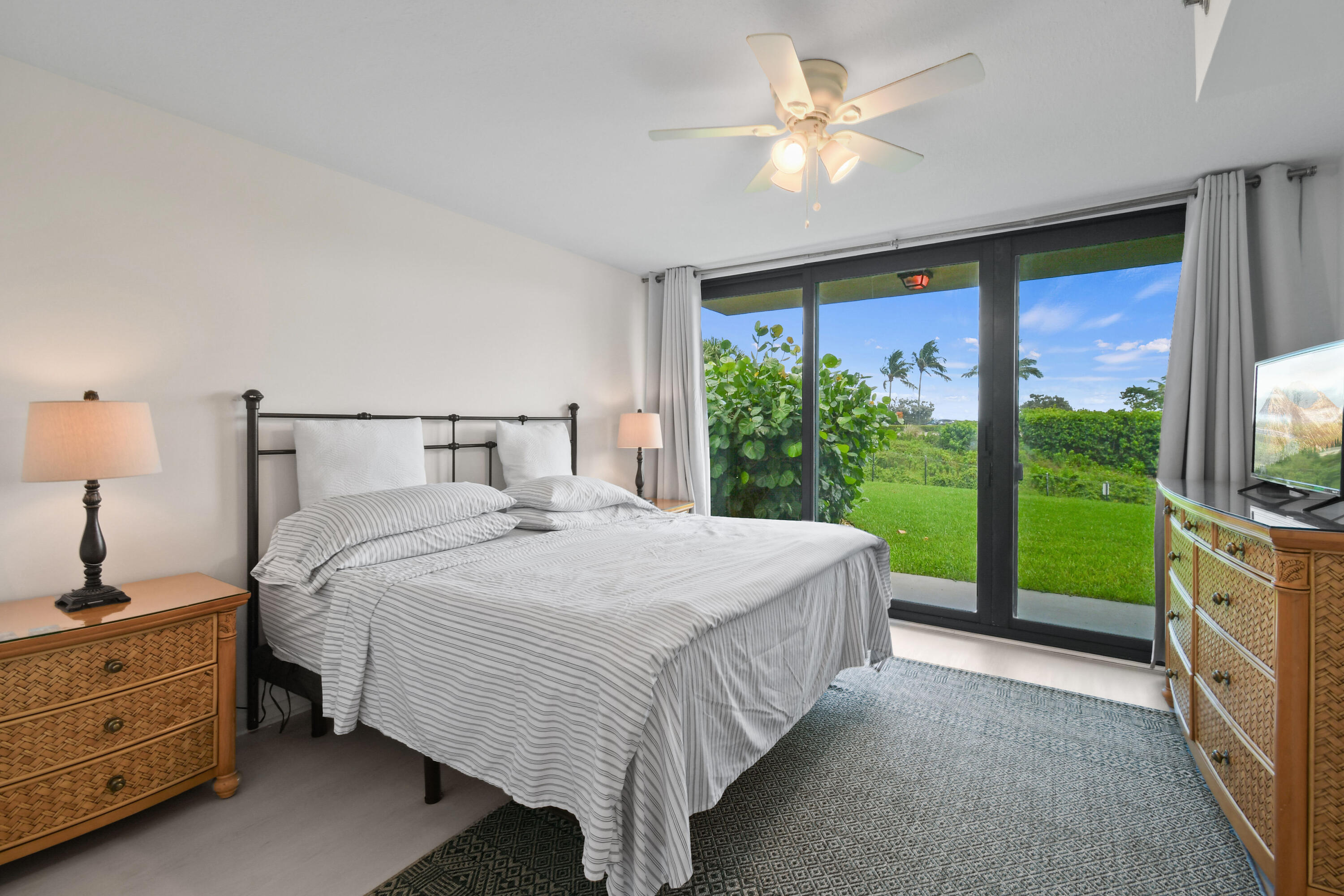 Undisclosed Address Jupiter, FL 33477 - Photo 10 of 23 a bedroom with a large bed and a large window