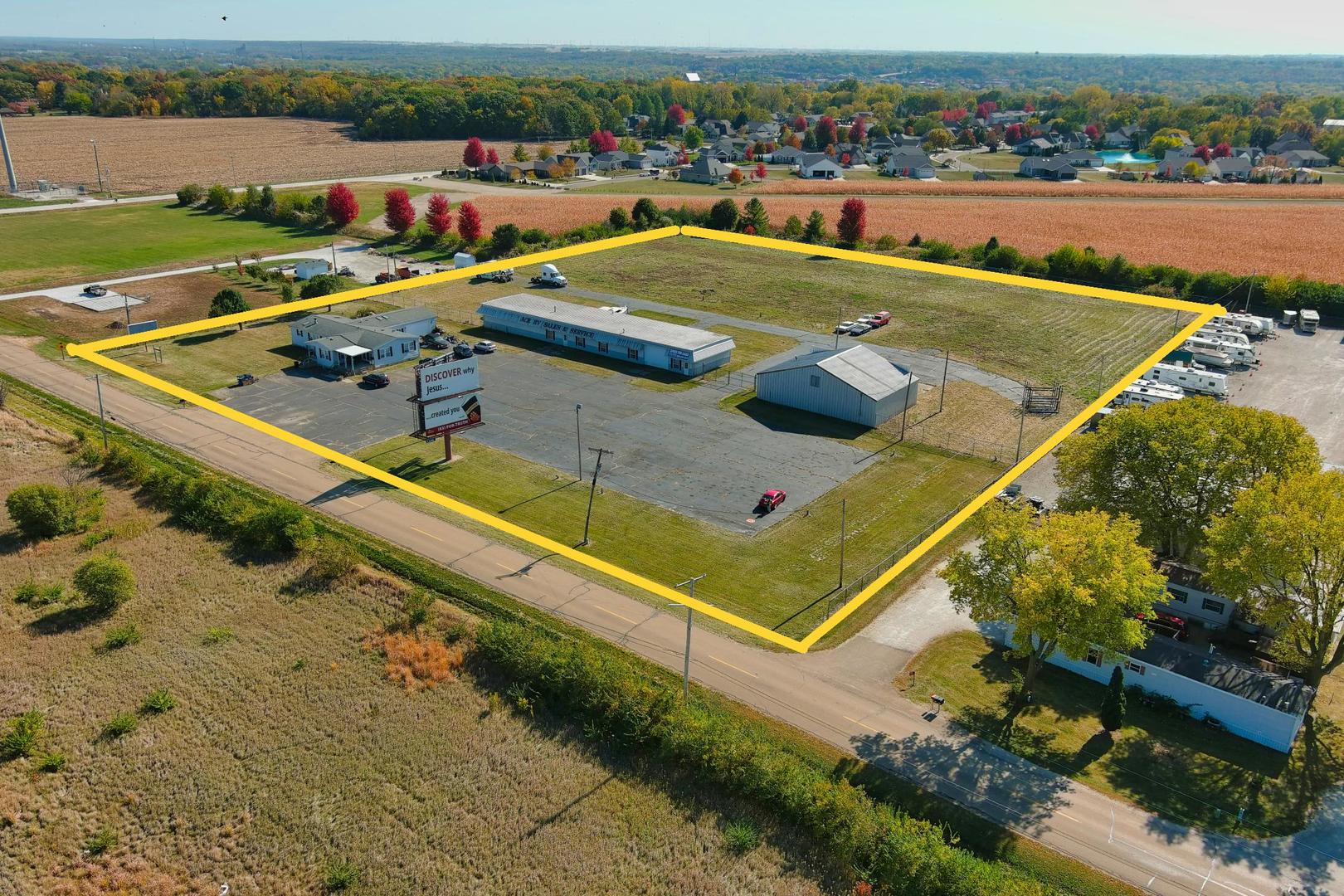 an aerial view of a house with a backyard and lake view