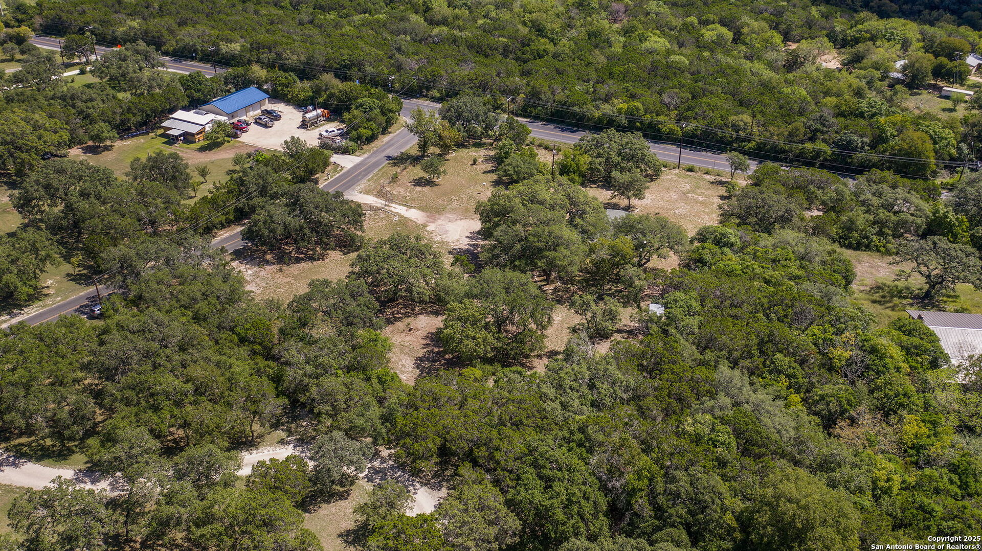 10096 Whip O Will Way Helotes, TX 78023 - Photo 11 of 39 a view of a forest with a houses