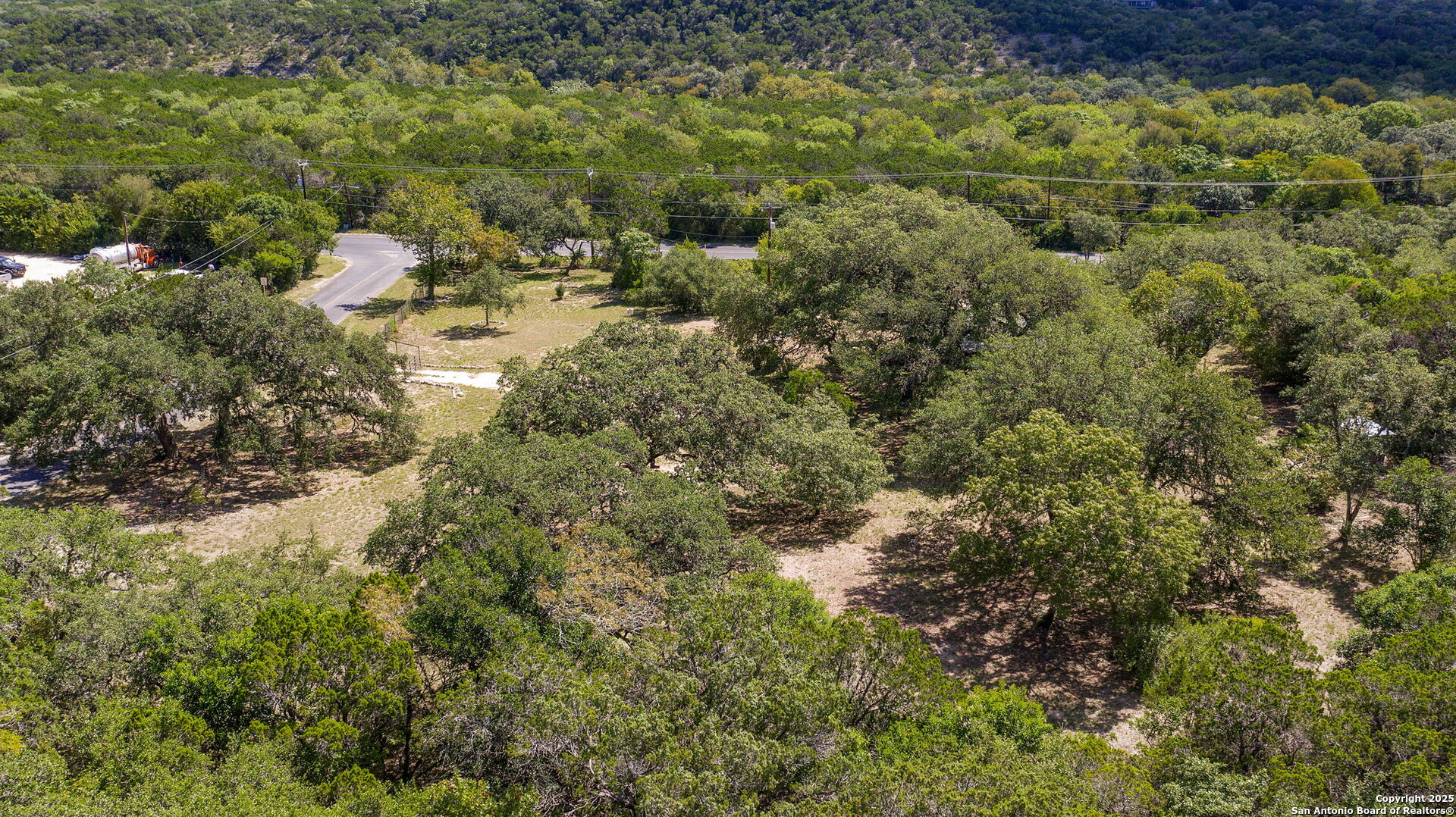 10096 Whip O Will Way Helotes, TX 78023 - Photo 16 of 39 a view of a forest with a houses