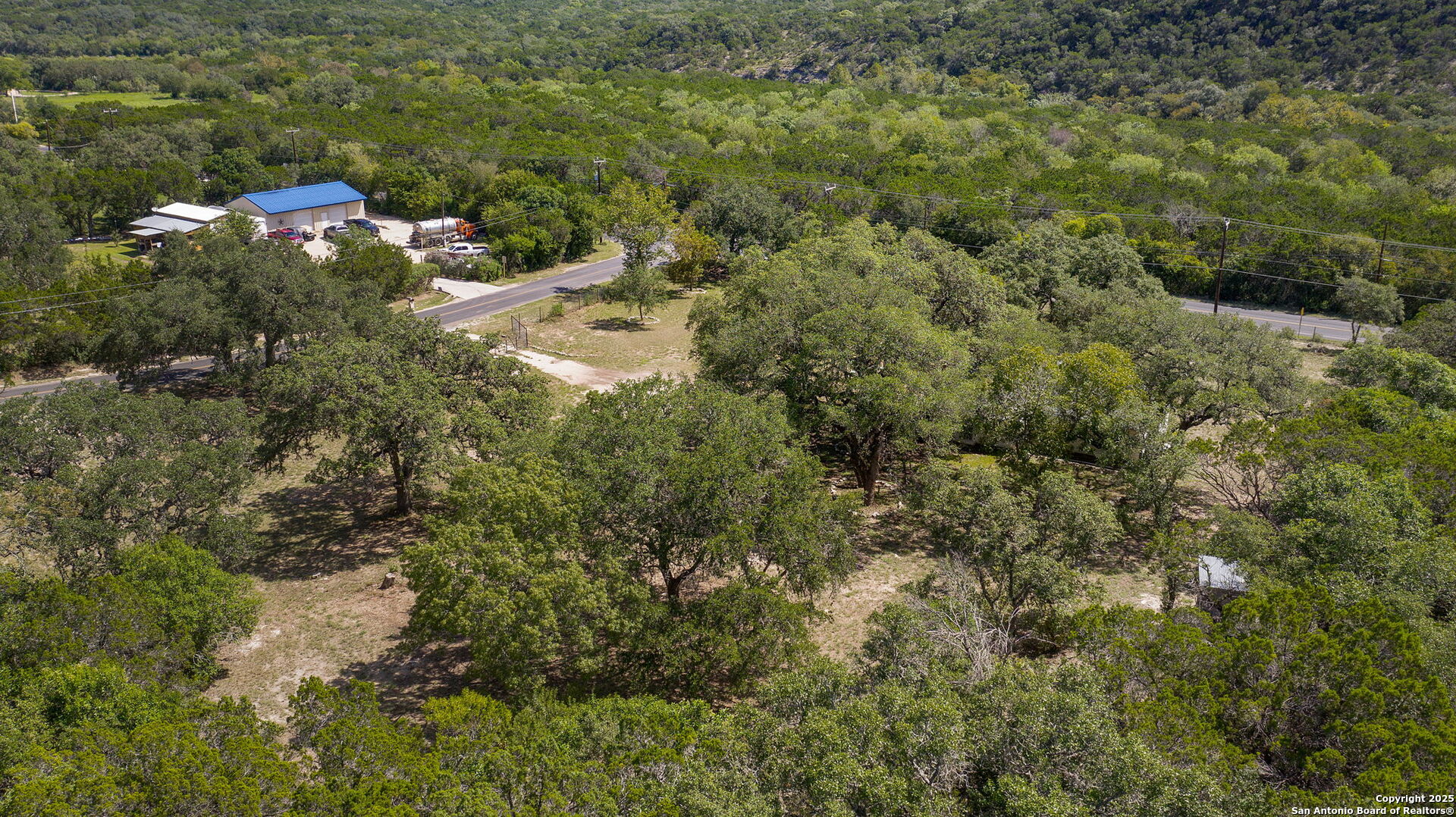 10096 Whip O Will Way Helotes, TX 78023 - Photo 17 of 39 a view of a house with a forest
